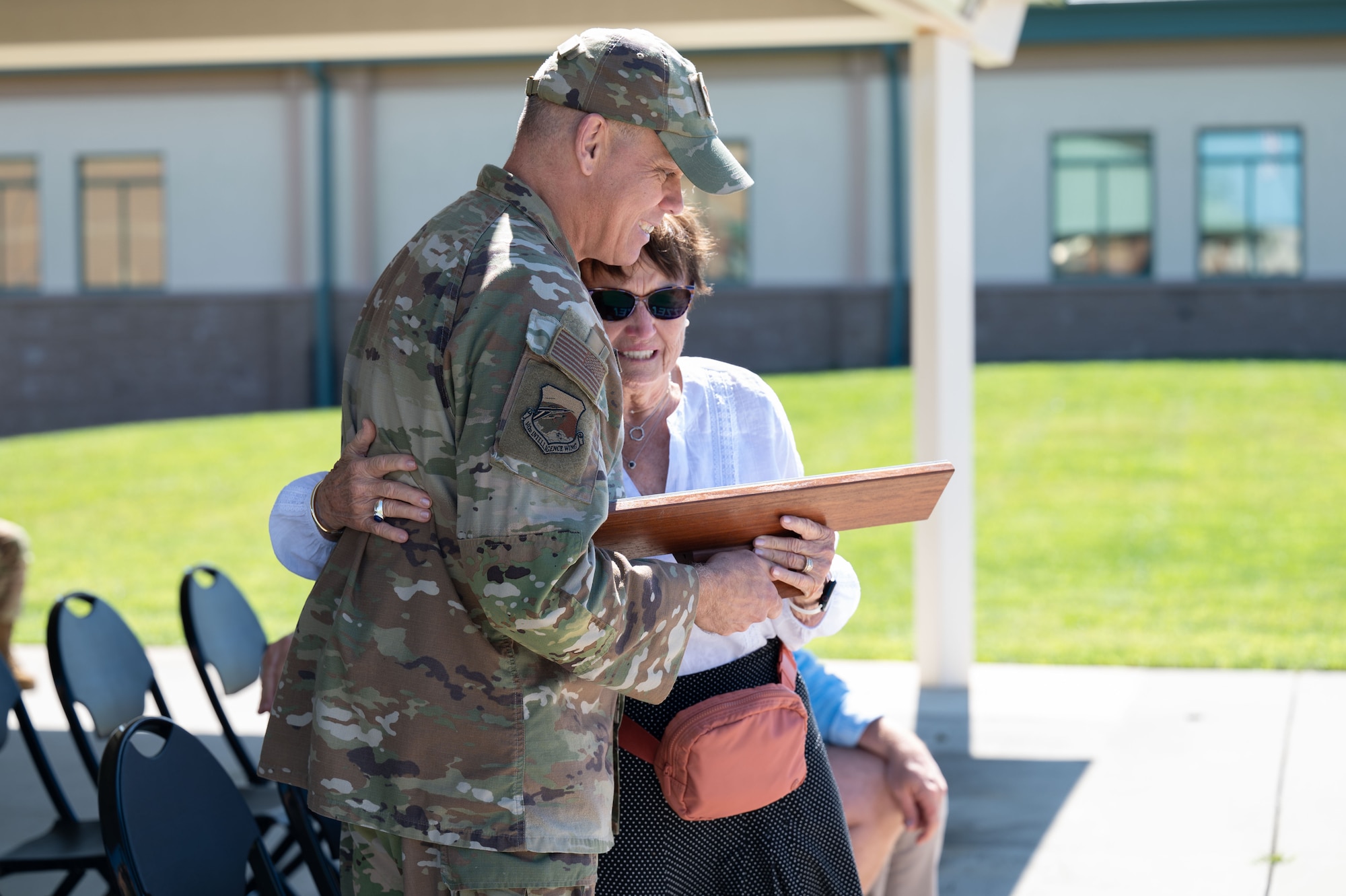 Photo of a ceremony honoring a fallen Airman, his family in attendance.