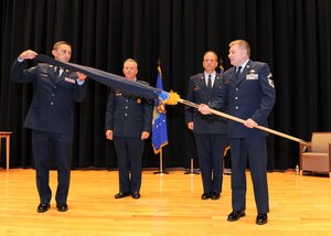 Former 655th Intelligence, Surveillance and Reconnaissance (ISR) Group commander and now retired Col. Douglas Drakeley, back right, and then-10th Air Force commander Maj. Gen. William Binger, back left, look on as the 655th ISRG flag is unsheathed for the first time during the group’s official stand-up ceremony Sept. 29, 2013, at Wright-Patterson AFB, Dayton, Ohio. (Archive Photo)