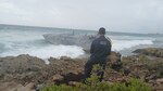 A Coast Guard Marine Science Technician responding to a pollution case inspects a derelict vessel Sept. 4, 2023, after the vessel washed ashore on Mona Island, Puerto Rico, Aug. 31, 2023. Resolve Marine cleanup crews, hired as the oil spill response organization for this case, completed the removal of 300 gallons of diesel, oily water waste and two cubic yards of oiled debris from the vessel’s tanks and interior Sept. 5, 2023.  (U.S. Coast Guard photo)
