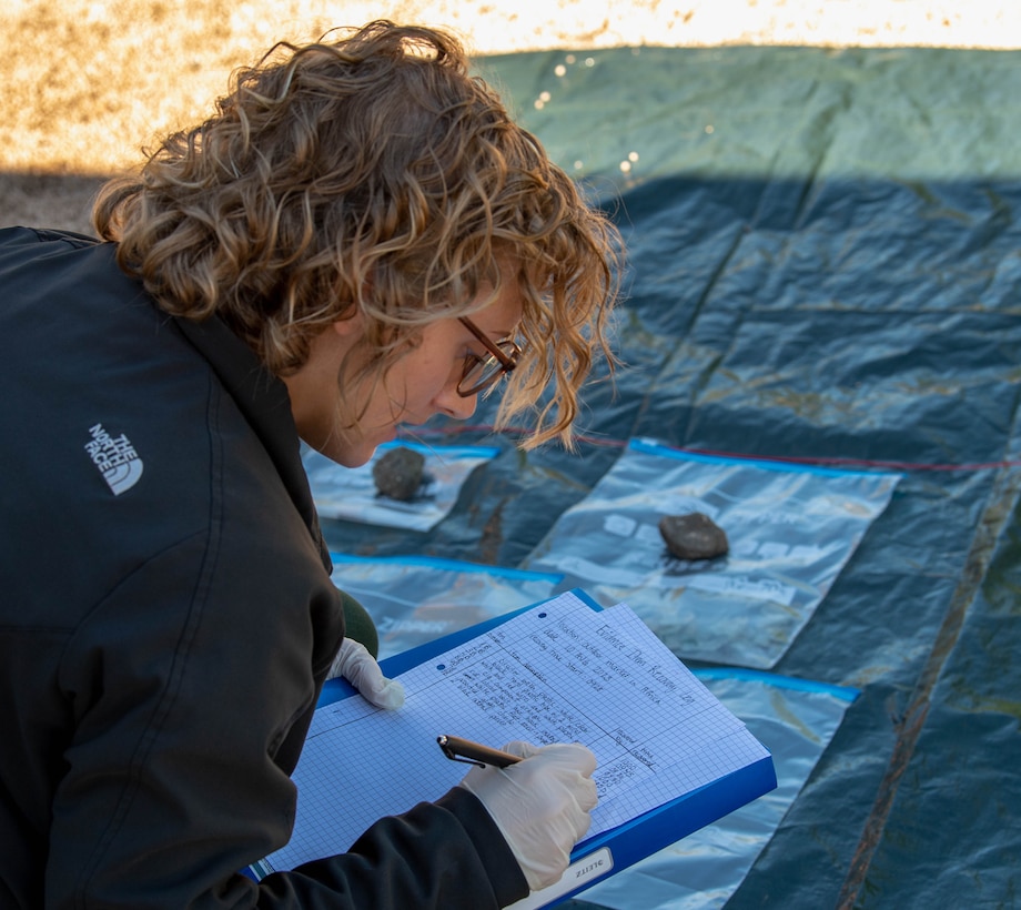 Charity Ludwig, U.S. Air Force Office of Special Investigations analyst, records pieces of evidence found by students in a Post Blast Training Course at Ramstein Air Base, Germany, Aug. 10, 2023. The week-long course is conducted by the Bureau of Alcohol, Tobacco, Firearms and Explosives to train students in explosives identification, the effects of explosions, how to recognize improvised explosive devices, and how to collect evidence from explosions. (U.S. Air Force photo by Airman Trevor Calvert)