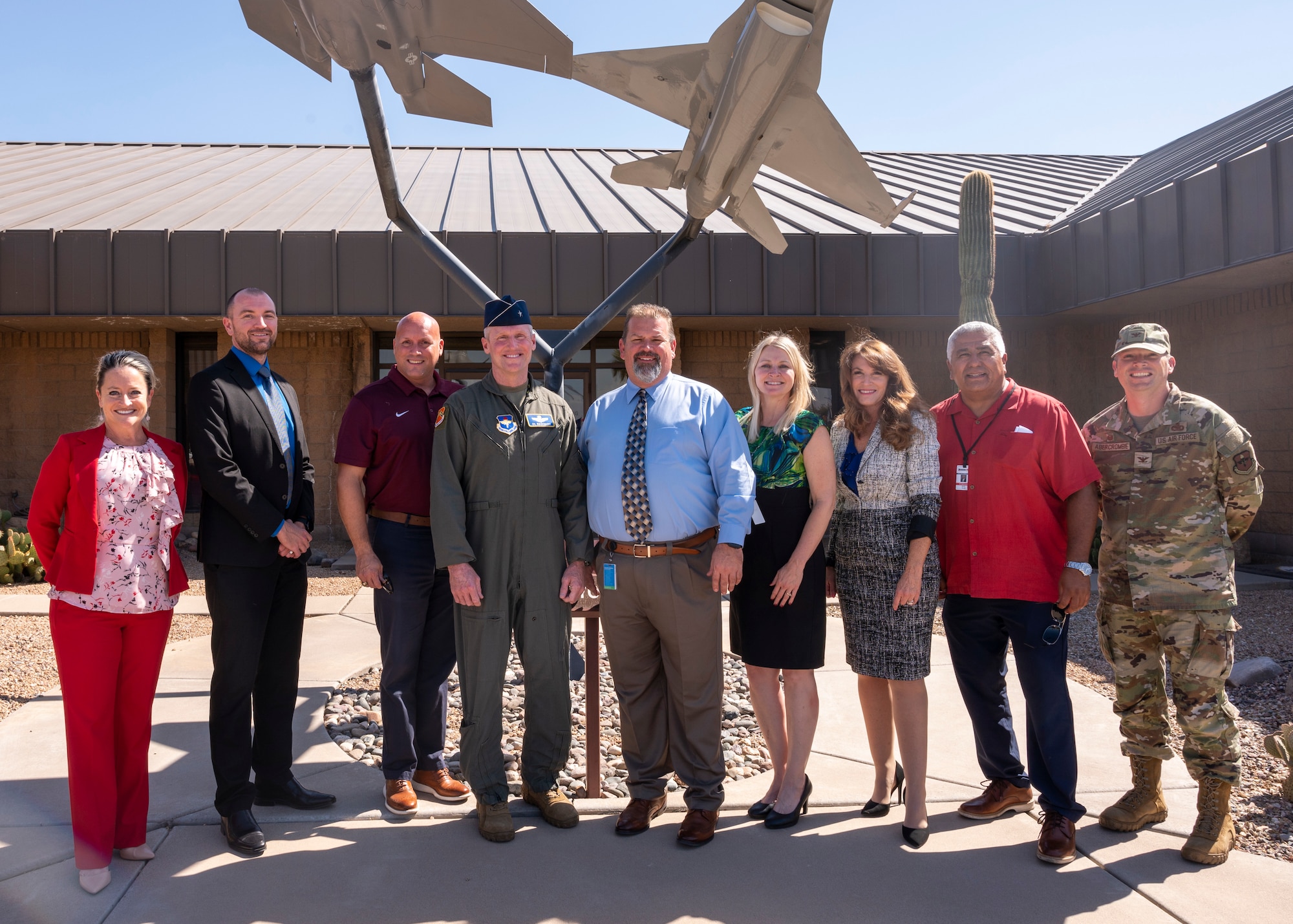 U.S. Air Force Brig. Gen. Jason Rueschhoff, center, 56th Fighter Wing commander, and Col. Peter Abercrombie II, far right, 56th Mission Support Group commander, pose for a photo with local school district superintendents during a base visit on August 30, 2023, at Luke Air Force Base, Arizona. The visit focused on topics including relocation, adapting to new schools, and other unique obstacles military children may encounter, some of which might be eased by programs like the Purple Star initiative. (U.S. Air Force photo by Staff Sgt. Collette Brooks)