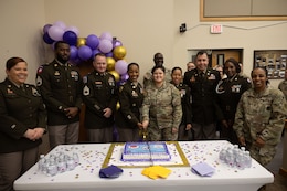 Soldiers of the 1st TSC cut cake at the FMMP