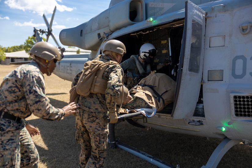 Troops train with simulated casualty and helicopter.