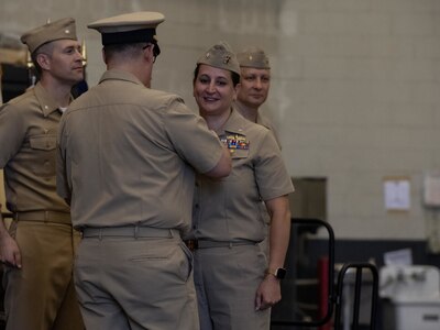 230906-N-DH811-1070 Virginia Beach, Va. (Sept. 6, 2023)— Cmdr. Laura Nevel,  a Reserve surface warfare officer, receives her command-at-sea pin during an assumption of command ceremony, Sept. 6, onboard Joint Expeditionary Base Little Creek-Fort Story. Navy Expeditionary Combat Command’s Maritime Expeditionary Security Force deploys globally and operates throughout the sea-to-shore and inland operating environment, protecting maritime infrastructure, providing insertion and extraction capabilities and supporting assets enabling maritime operations. (U.S. Navy photo by Mass Communication Specialist 1st Class Benjamin T. Liston)