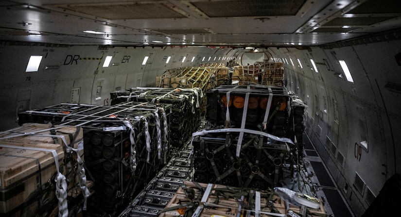 A photo shows pallets of ammunition on a cargo transport airplane.