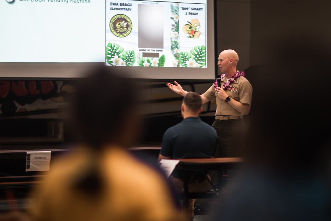 U.S. Marine Corps Chief Warrant Officer 2 Christopher Simser Jr., Marine Corps Base Hawaii Gunner, speaks to families and community members at Ewa Beach Elementary School during curriculum night, Ewa Beach, Hawaii, Aug. 24, 2023. Pu’uloa Range Training Facility leadership participated in the event as a show of support for local schools. (U.S. Marine Corps photo by Cpl. Christian Tofteroo)