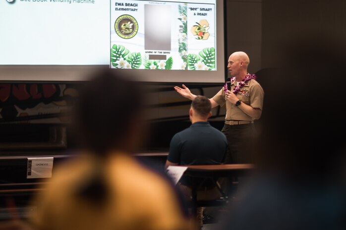 U.S. Marine Corps Chief Warrant Officer 2 Christopher Simser Jr., Marine Corps Base Hawaii Gunner, speaks to families and community members at Ewa Beach Elementary School during curriculum night, Ewa Beach, Hawaii, Aug. 24, 2023. Pu’uloa Range Training Facility leadership participated in the event as a show of support for local schools. (U.S. Marine Corps photo by Cpl. Christian Tofteroo)