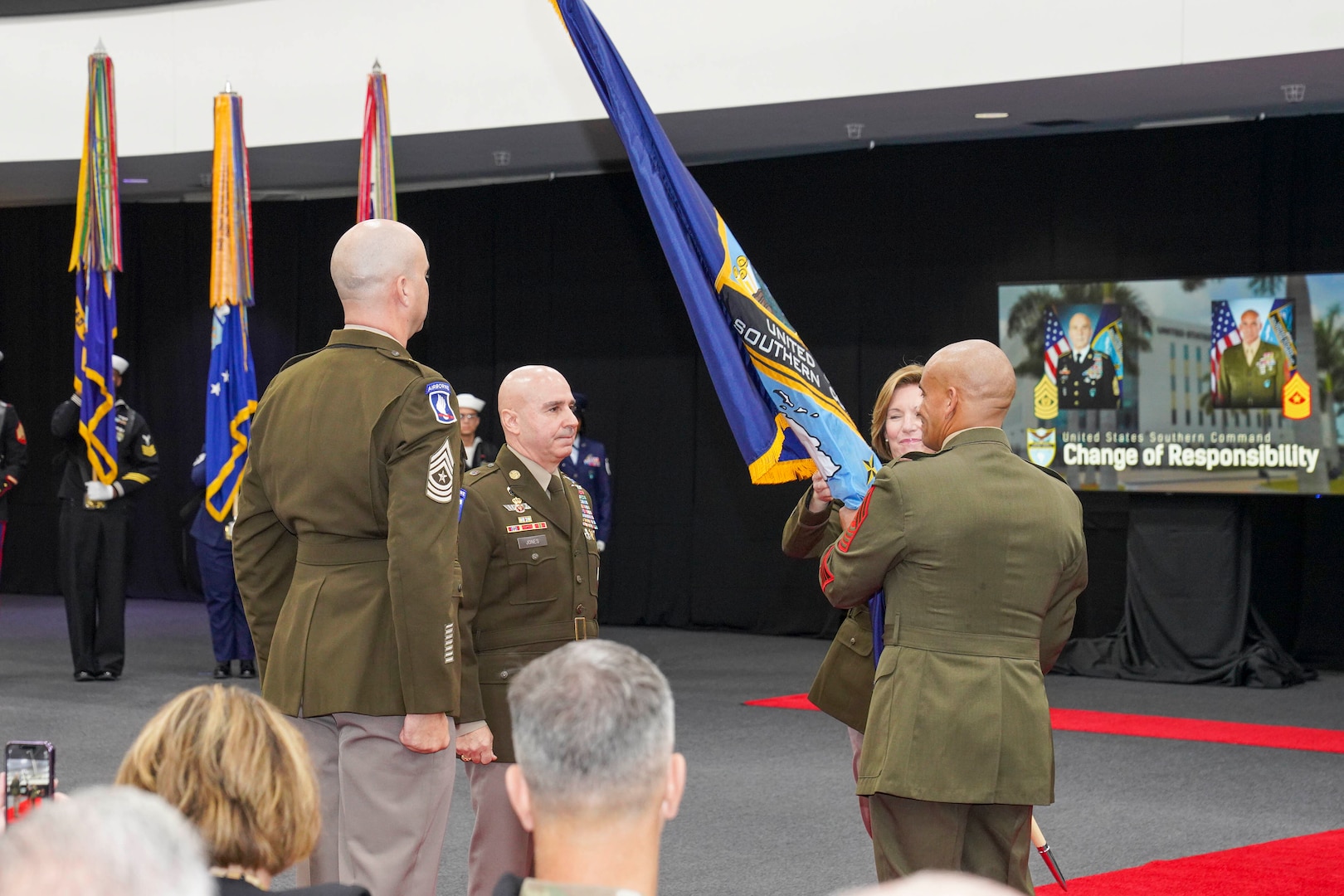 The commander of U.S. Southern Command, Army Gen. Laura Richardson, and U.S. Marine Sgt. Maj. Rafael Rodriguez, SOUTHCOM Senior Enlisted Leader, pass the guidon during a change of responsibility ceremony at the command’s headquarters.