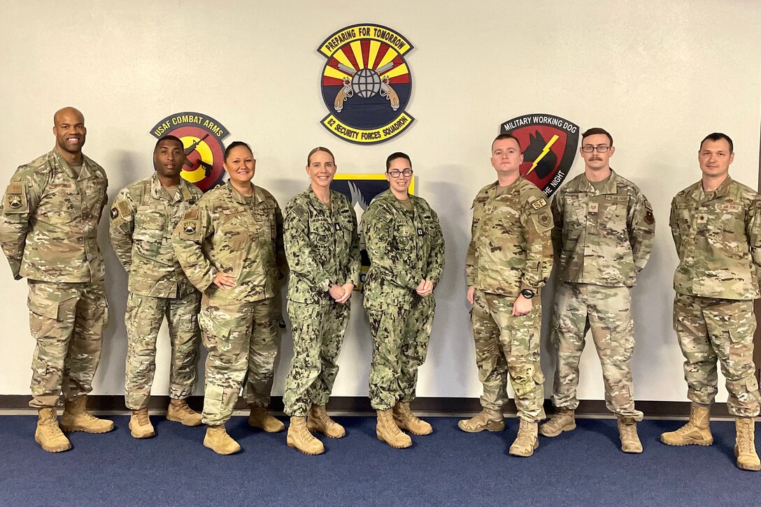 Air Force and Navy personnel stand together