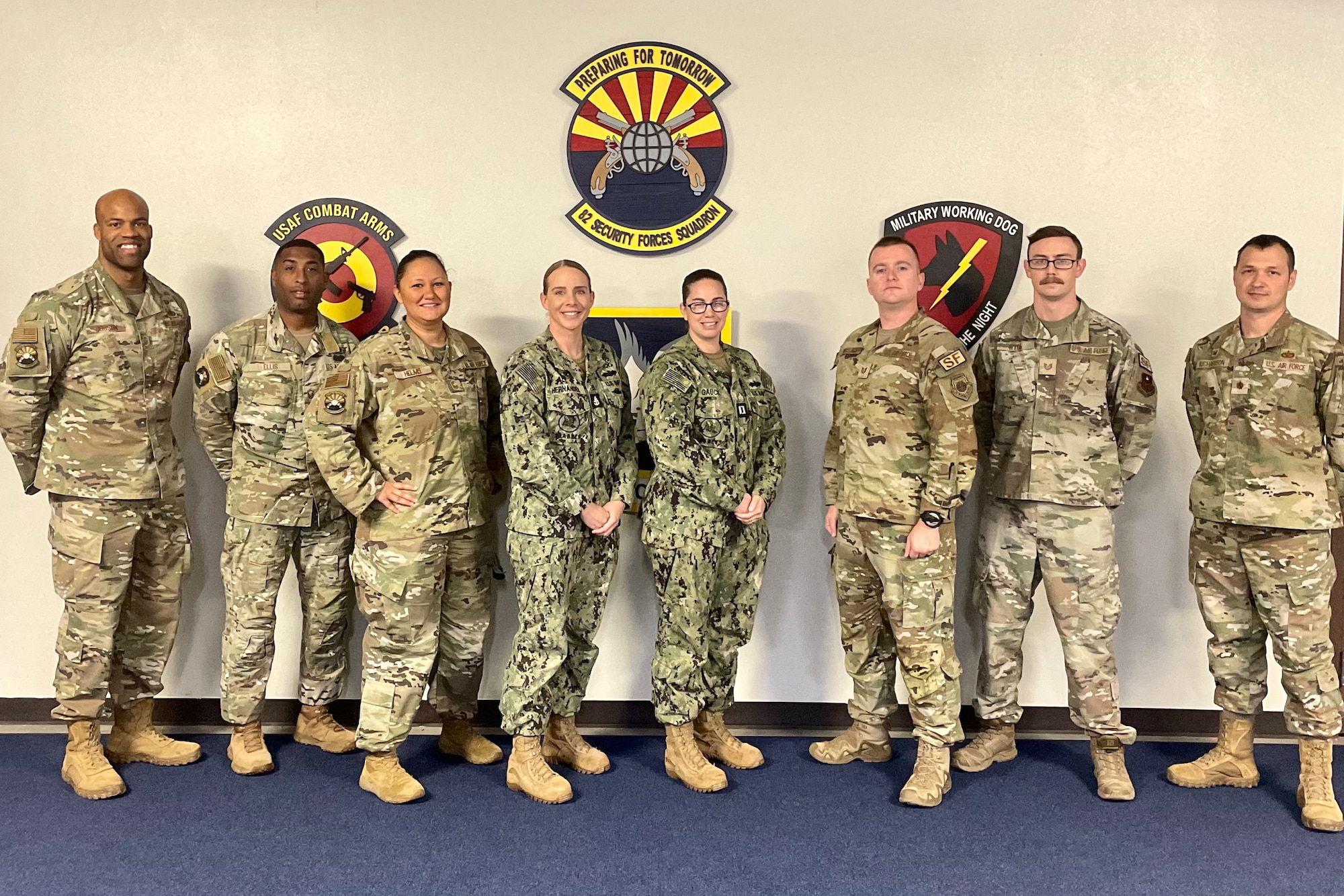 Air Force and Navy personnel stand together