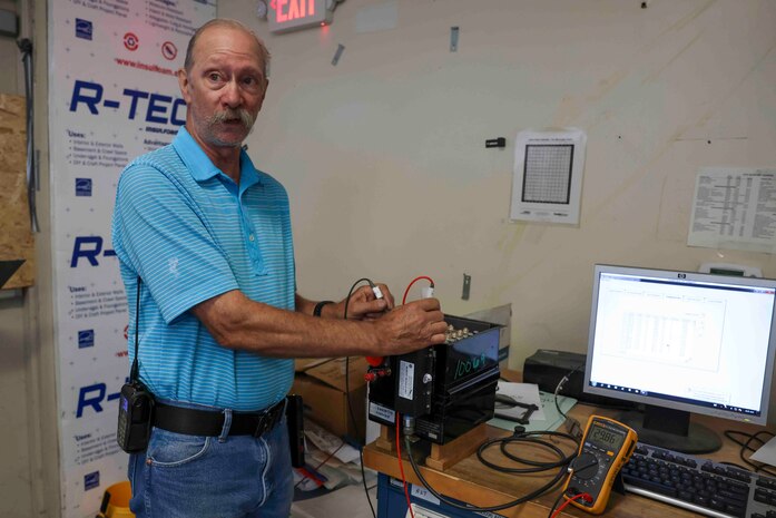 Theodore Cochran, 9th Maintenance Squadron lead battery technician, explains the importance of checking the voltage of the battery used on the U-2 Dragon Lady, and the T-38 Talon, with a fluke multimeter, Aug. 11, 2023 at Beale Air Force Base, California.