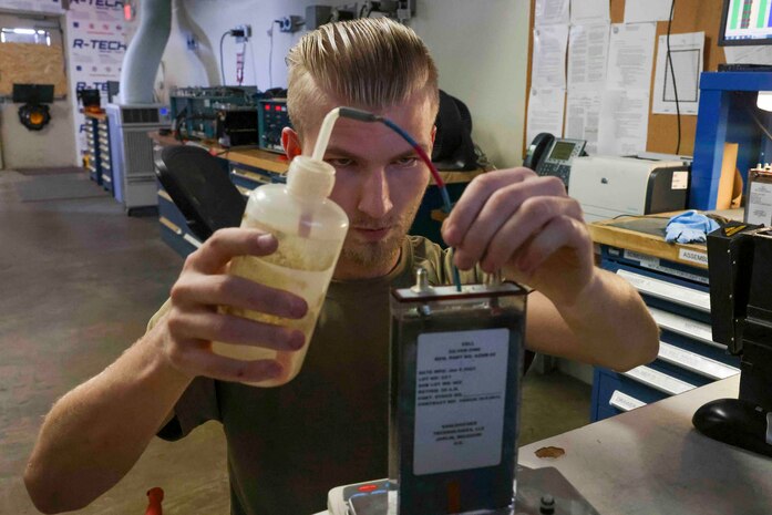U.S. Air Force Senior Airman Maxwell Karline, 9th Maintenance Squadron electrical and environmental systems craftsmen, adjusts the “wet” weight of a silver zinc cell Aug. 11, 2023, at Beale Air Force Base, California.