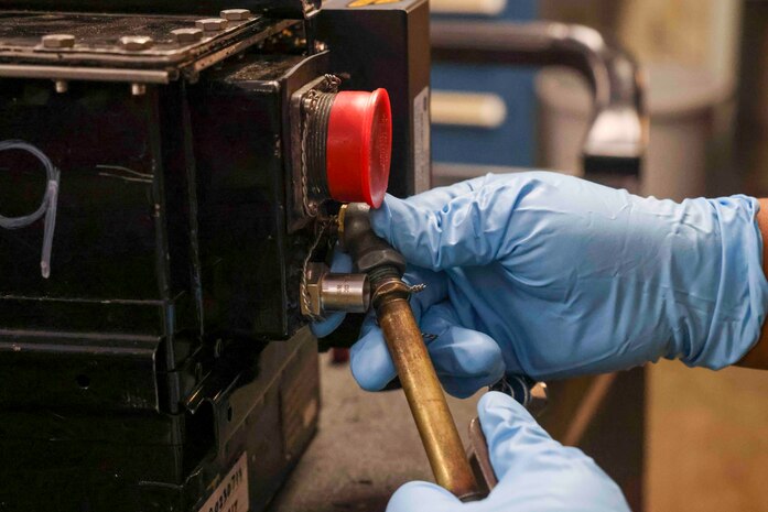 U.S. Air Force Staff Sgt. Mary Daria, 9th Maintenance Squadron electrical and environmental systems craftsmen, uses a nitrogen pressure hose to push pressure into the battery case Aug. 11, 2023, at Beale Air Force Base, California.