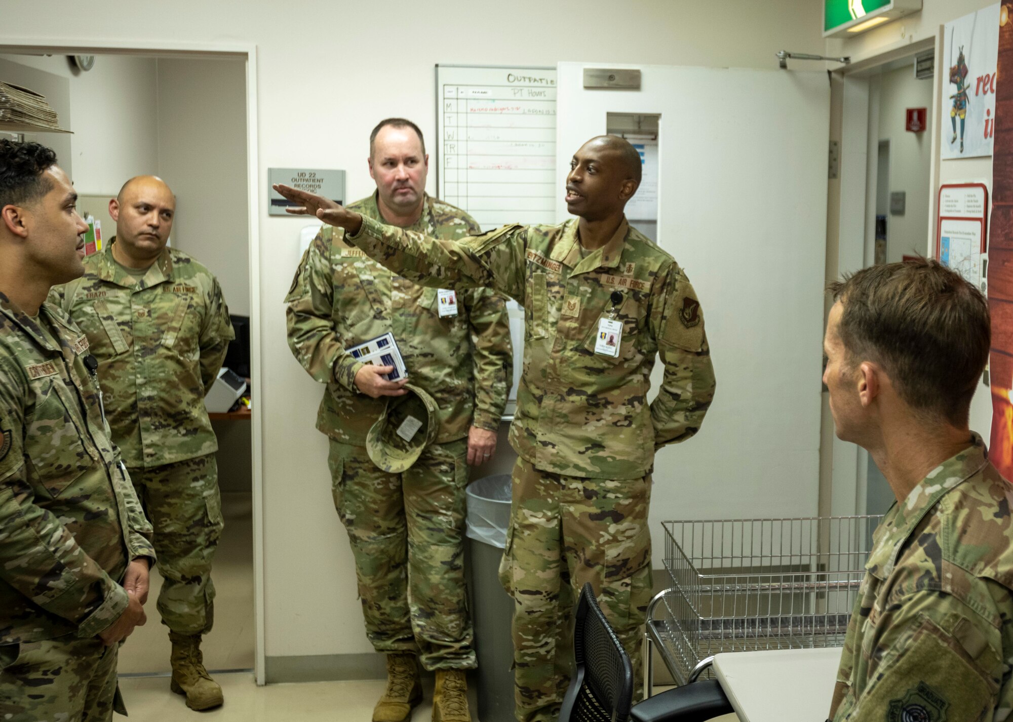 U.S. Air Force Tech. Sgt. Alexander Entzminger, TRICARE Operations and Patient Administration Flight records noncommissioned officer in charge, explains the process of transferring medical records from physical to digital copies during a Wild Weasel Walk-through at Misawa Air Base, Japan.