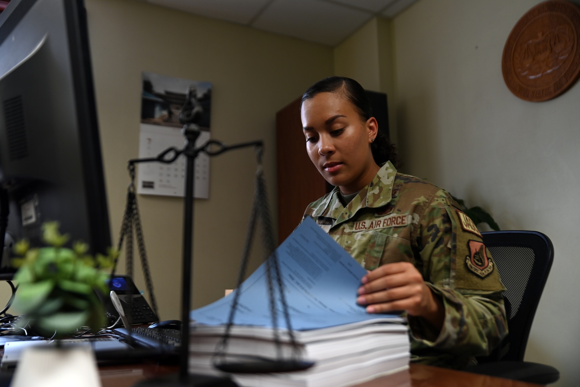Tech. Sgt. Micaela Mahan, 7th Air Force Office of the Staff Judge Advocate, reviews paperwork in her office at Osan Air Base, Republic of Korea, July 20, 2023.