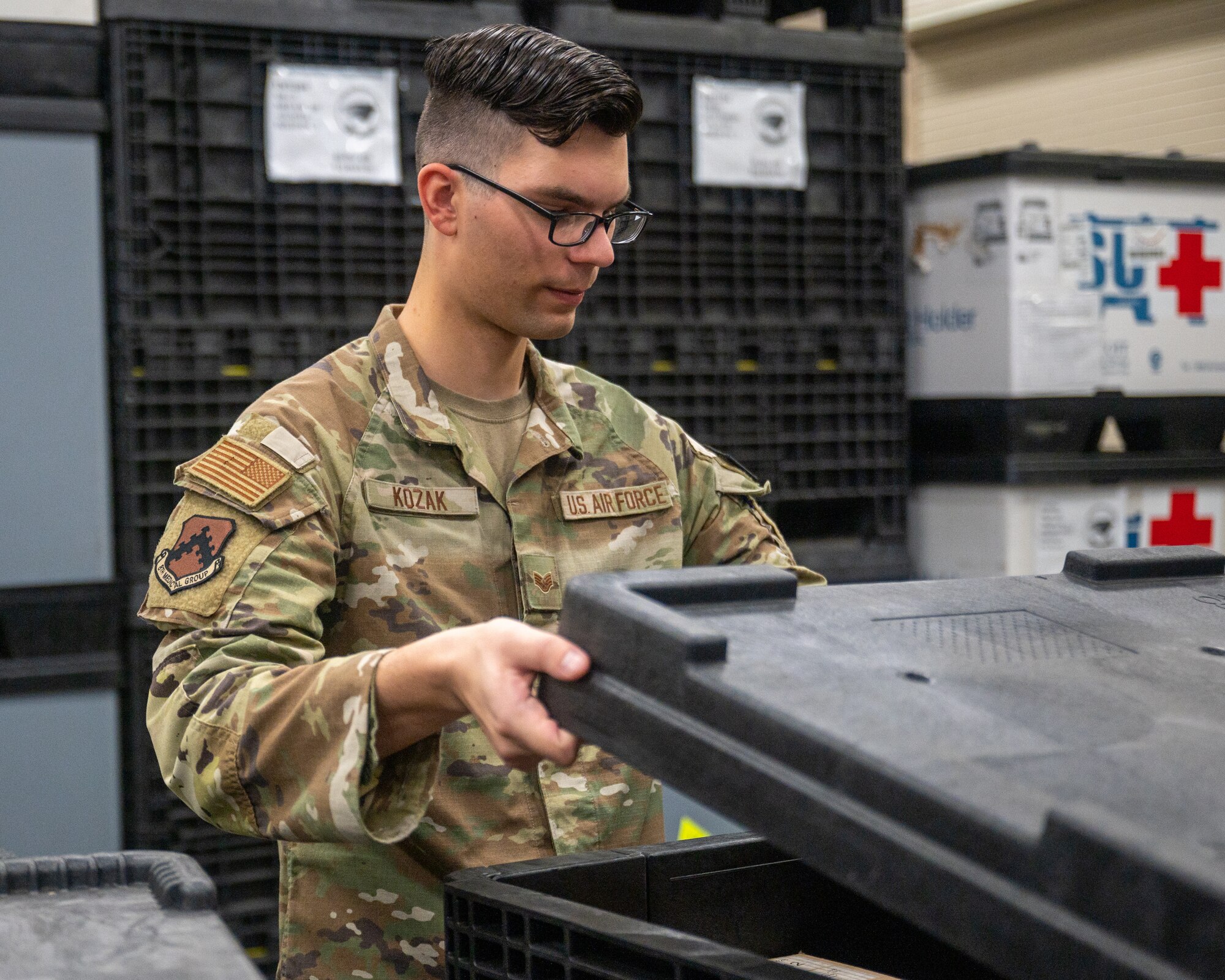 Staff Sgt. Nicholas Kozak, 8th Healthcare Operations Squadron non-commissioned officer in charge of contingency support, opens the lid to a storage crate containing medical supplies at Kunsan Air Base, Republic of Korea, Aug. 31, 2023.