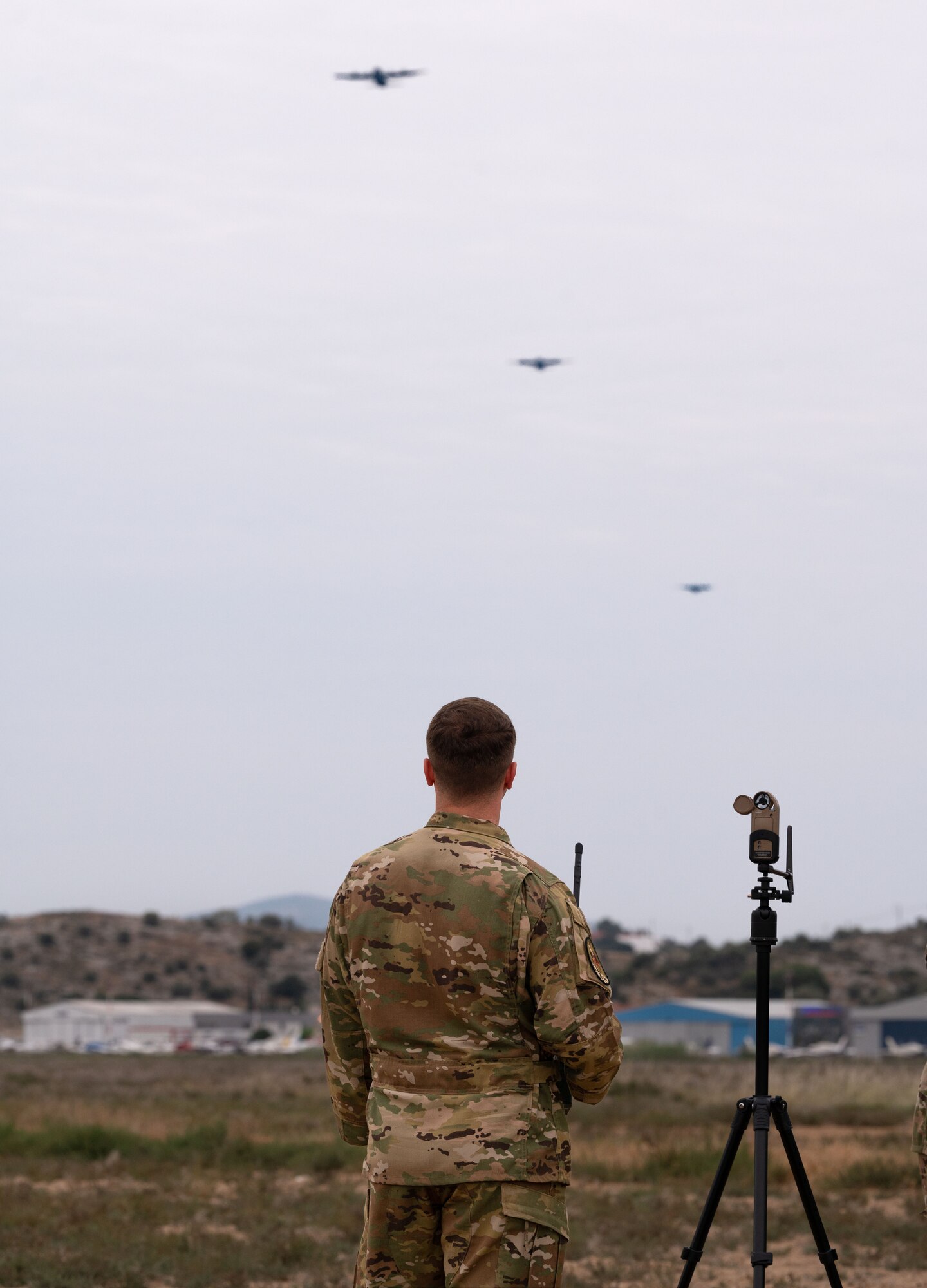 A man communicates to aircraft with a radio