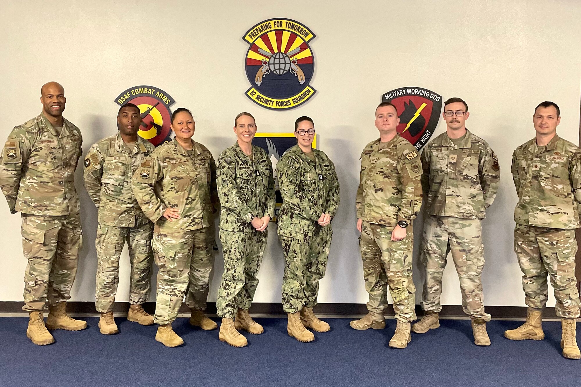 Air Force and Navy personnel stand together