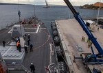 PORT EDEN (Aug. 22, 2023) Sailors aboard the Arleigh Burke-class guided-missile destroyer USS Rafael Peralta (DDG 115) guide an SM-2 missile container into a vertical launching system (VLS) tube during an SM-2 missile reload, Aug. 22. Rafael Peralta is assigned to Task Force 71/Destroyer Squadron (DESRON) 15, the Navy’s largest forward-deployed DESRON and the U.S. 7th Fleet’s principal surface force. (U.S. Navy photo by Mass Communication Specialist 2nd Class Colby A. Mothershead)