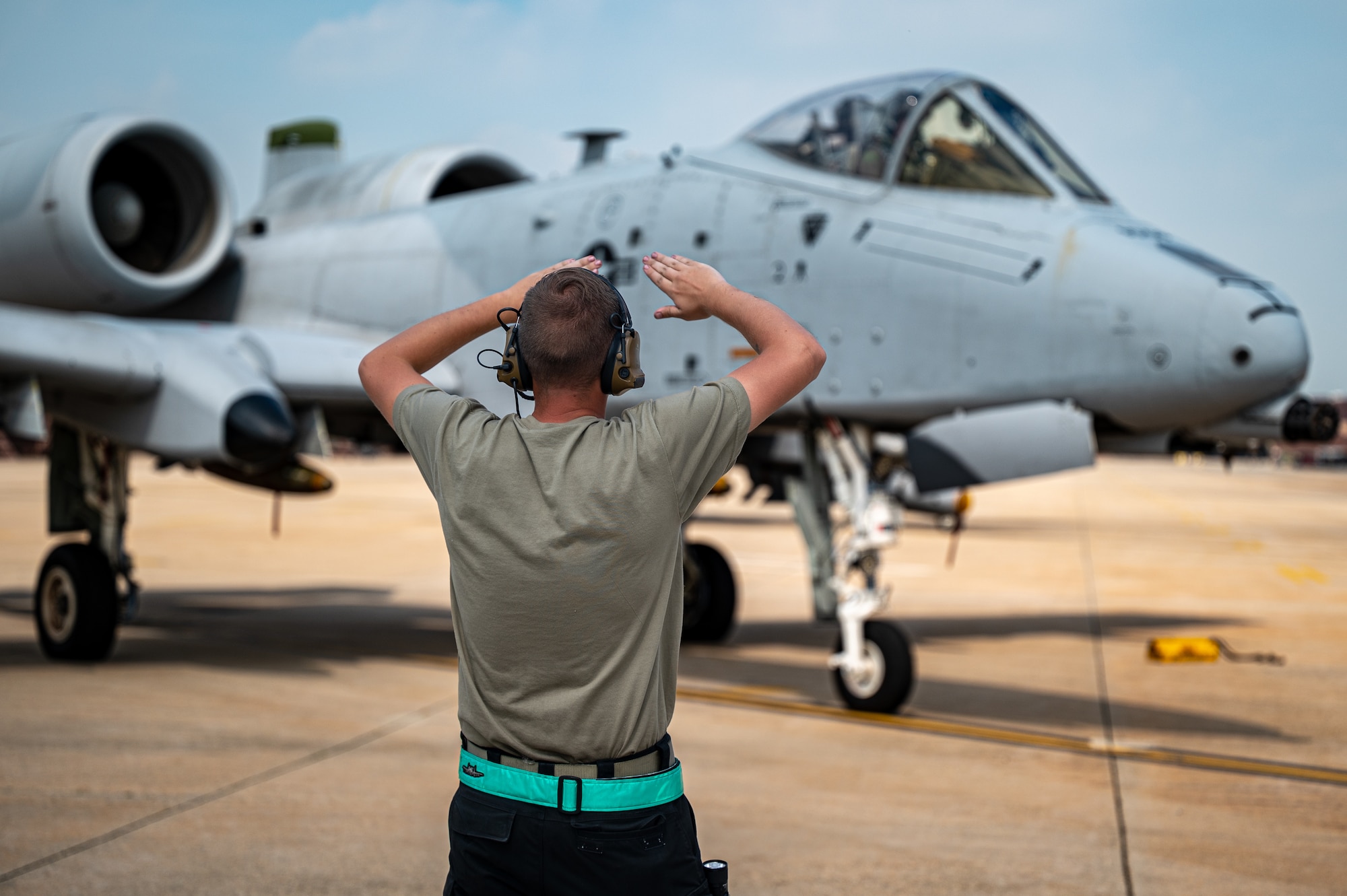 U.S. Air Force Airman 1st Class Airman 1st Class Mathew Ledbeter, 25th Fighter Generation Squadron crew chief, directs an A-10C Thunderbolt II before takeoff at Osan Air Base, Republic of Korea, Aug. 31, 2023. 25th FGS Crew chiefs maintain and ensure the preparedness of 25th FS aircraft for immediate combat readiness. (U.S. Air Force photo by Staff Sgt. Thomas Sjoberg)
