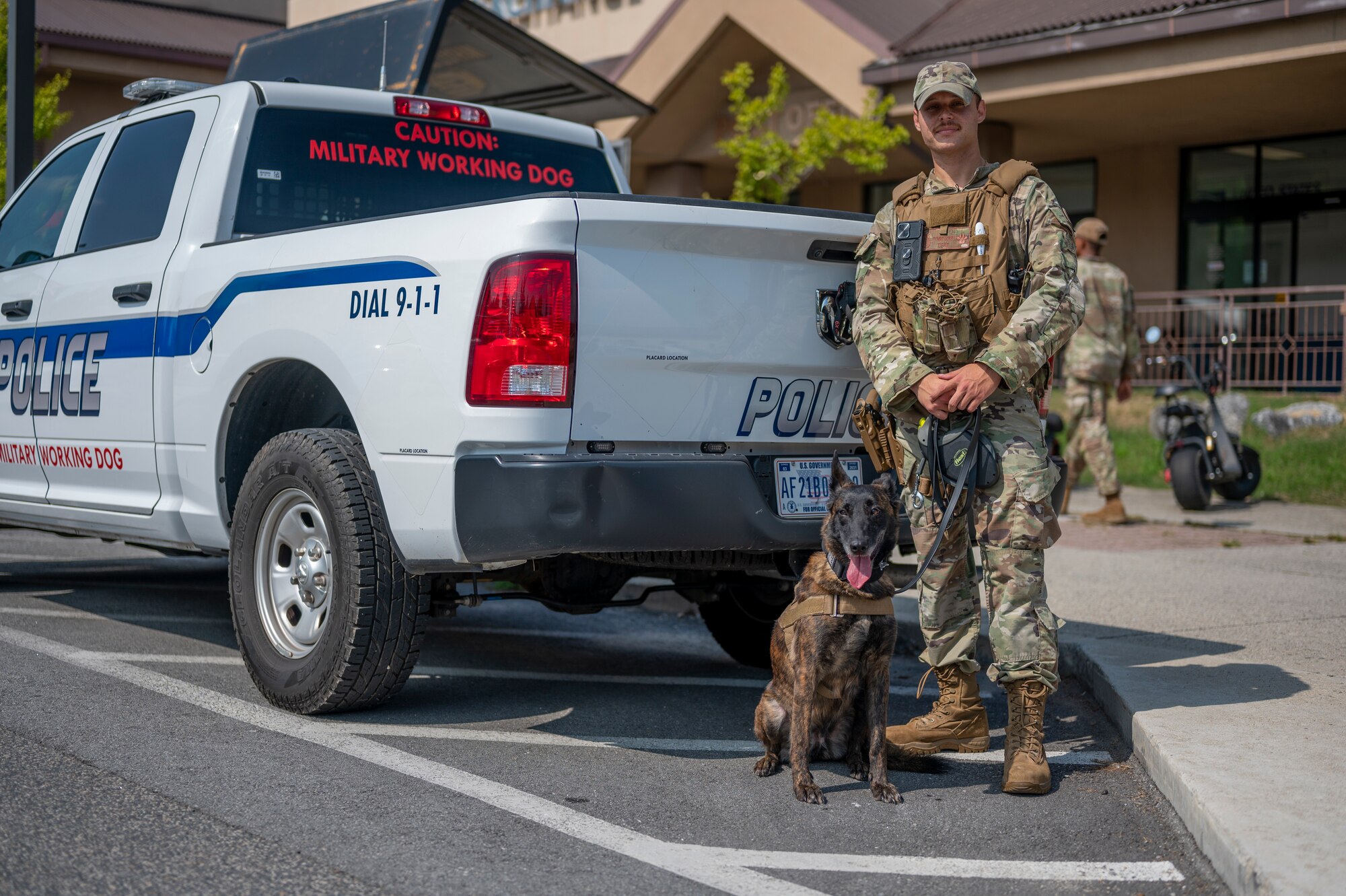 U.S. Air Force Senior Airman Tommi Jones, 51st Security Forces Squadron military working dog handler, poses for a photo with MWD Cora, at Osan Air Base, Republic of Korea, Sept. 6, 2023. Jones and Cora completed routine detection training in the base theater, improving their ability to work together as a team to defend the base. (U.S. Air Force photo by Senior Airman Aaron Edwards)