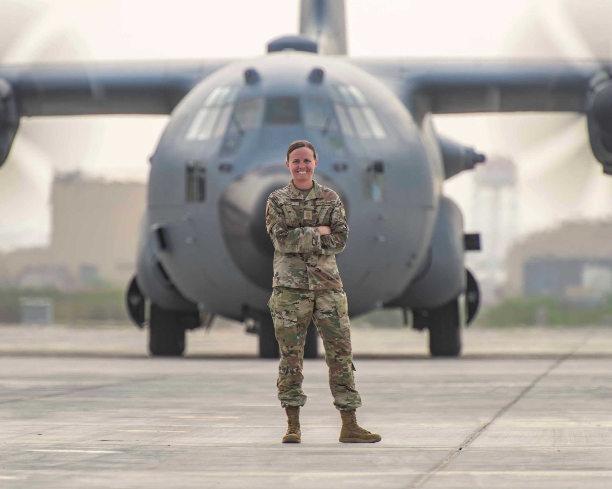 Photo of a woman standing in front of an airplane