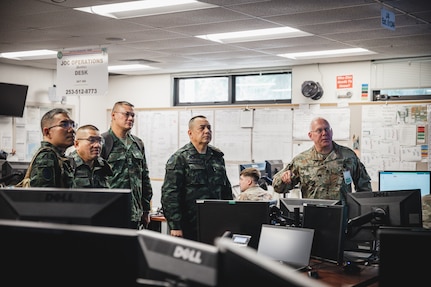 1st Sgt. Rich Little, Joint Operations Center Supervisor, Joint Force Headquarters - Washington briefs LTG Nirandorn Srikacha, Deputy Chief of Staff for Civil Affairs, Royal Thai Army