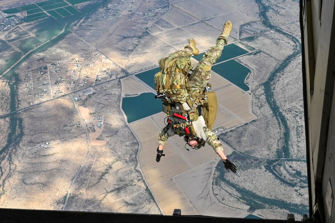 An airman jumps from a plane.