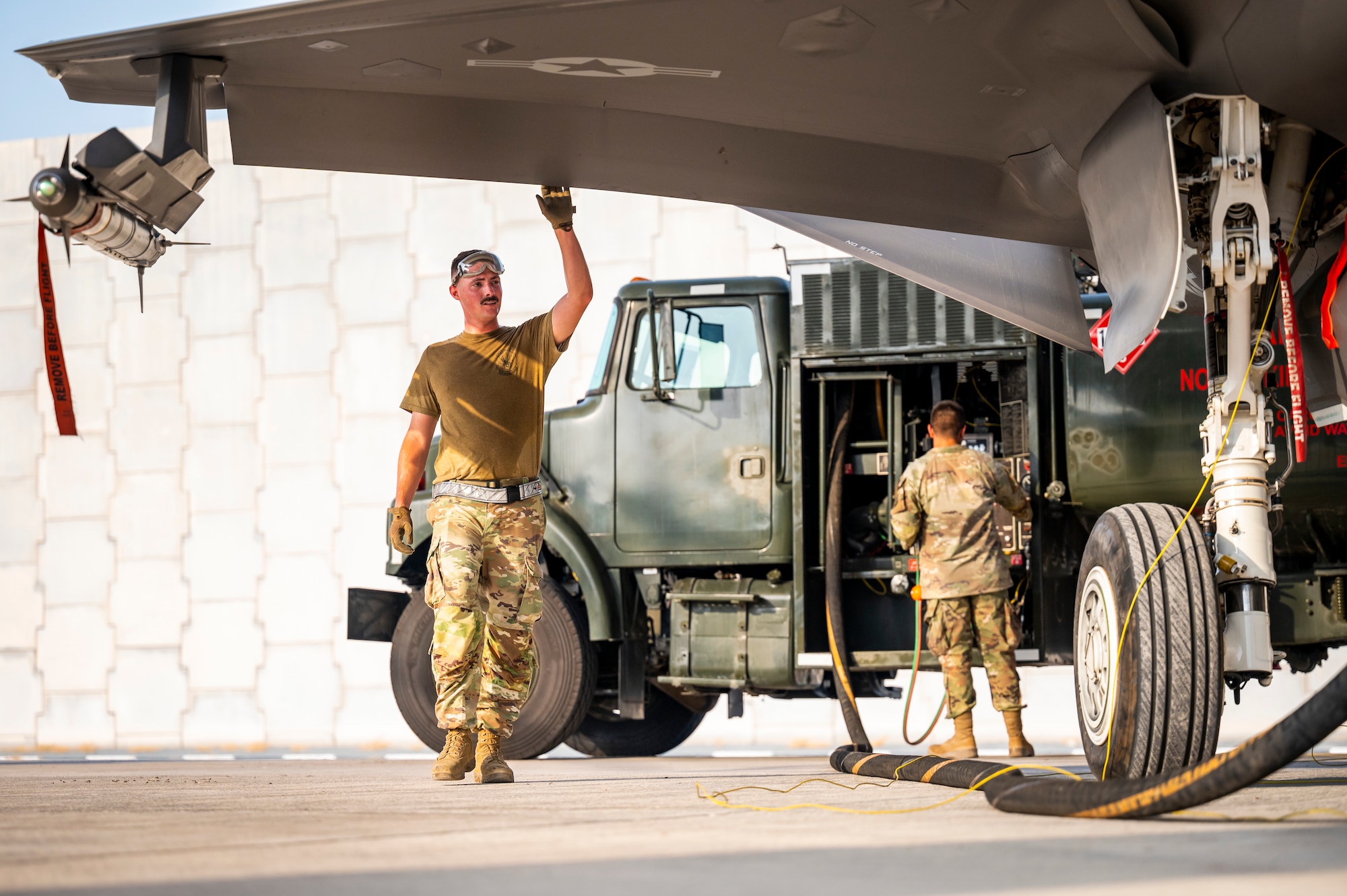 People fueling an aircraft