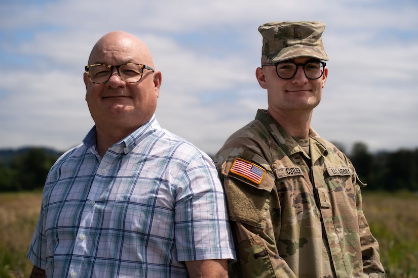 Father poses with newly commissioned son.