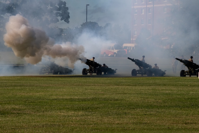 Field Artillery guns fire during a ceremony.