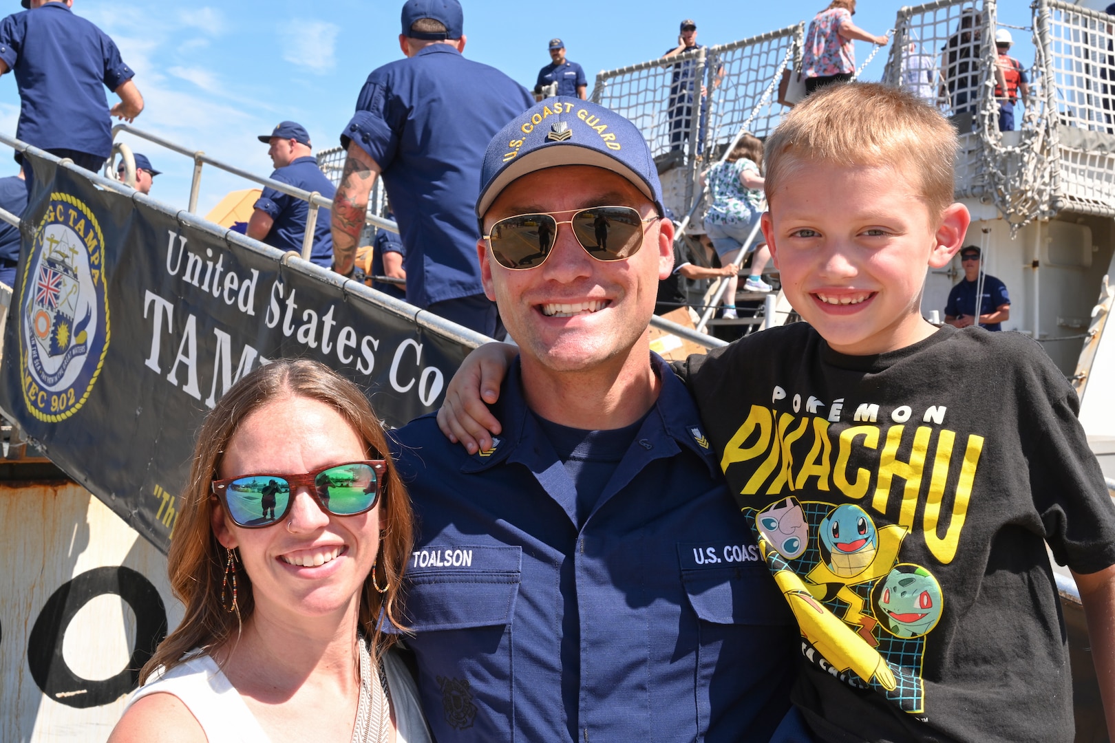 Petty Officer 1st Class Christopher Toalson, a machinery technician assigned to U.S. Coast Guard Cutter Tampa (WMEC 902), poses for a photograph with his wife and son, Sept. 5, 2023, in Portsmouth, Virginia following the completion of Tampa's 67-day patrol in the Florida Straits and Windward Passage. Tampa deployed in support of Homeland Security Task Force — Southeast and conducted maritime safety and security missions. (U.S. Coast Guard photo by Petty Officer 2nd Class Brandon Hillard)