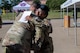 Two Army soldiers embrace in a hug.