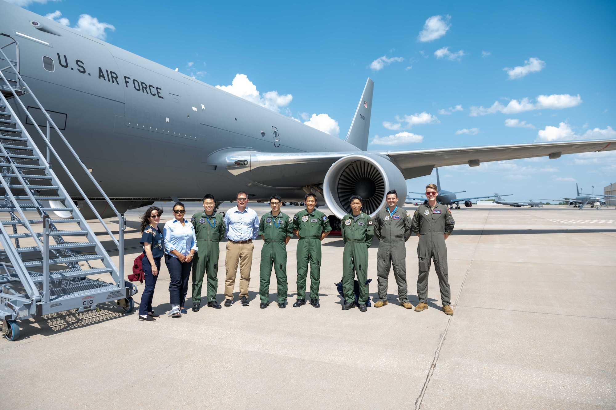 Members from the 405th Air Refueling Squadron, Japan Air Self-Defense, pose for a photo before touring a KC-46A Pegasus with Airmen from the 344th Air Refueling Squadron Aug. 29, 2023, at McConnell Air Force Base, Kansas. McConnell Airmen informed the JSDAF members how to effectively operate the KC-46 during their three-day tour of the base. (U.S. Air Force photo by Airman 1st Class William Lunn)