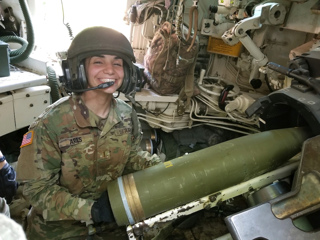 Army Capt. Graciela Arias Tharp, commander of Charlie Battery of the 2nd Battalion, 138th Field Artillery, loads a round into the weapon system prior to firing it downrange during their annual training.