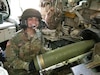 Army Capt. Graciela Arias Tharp, commander of Charlie Battery of the 2nd Battalion, 138th Field Artillery, loads a round into the weapon system prior to firing it downrange during their annual training.