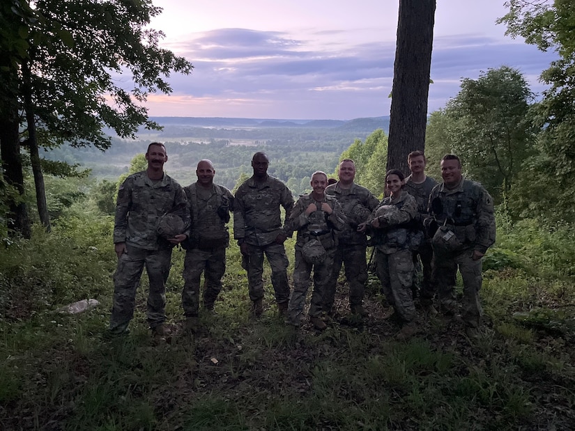 Army Capt. Graciela Arias Tharp stops for a group photo while on the observation point observing illumination rounds during one of the firing exercises that were part of the 'Top Gun' competition.