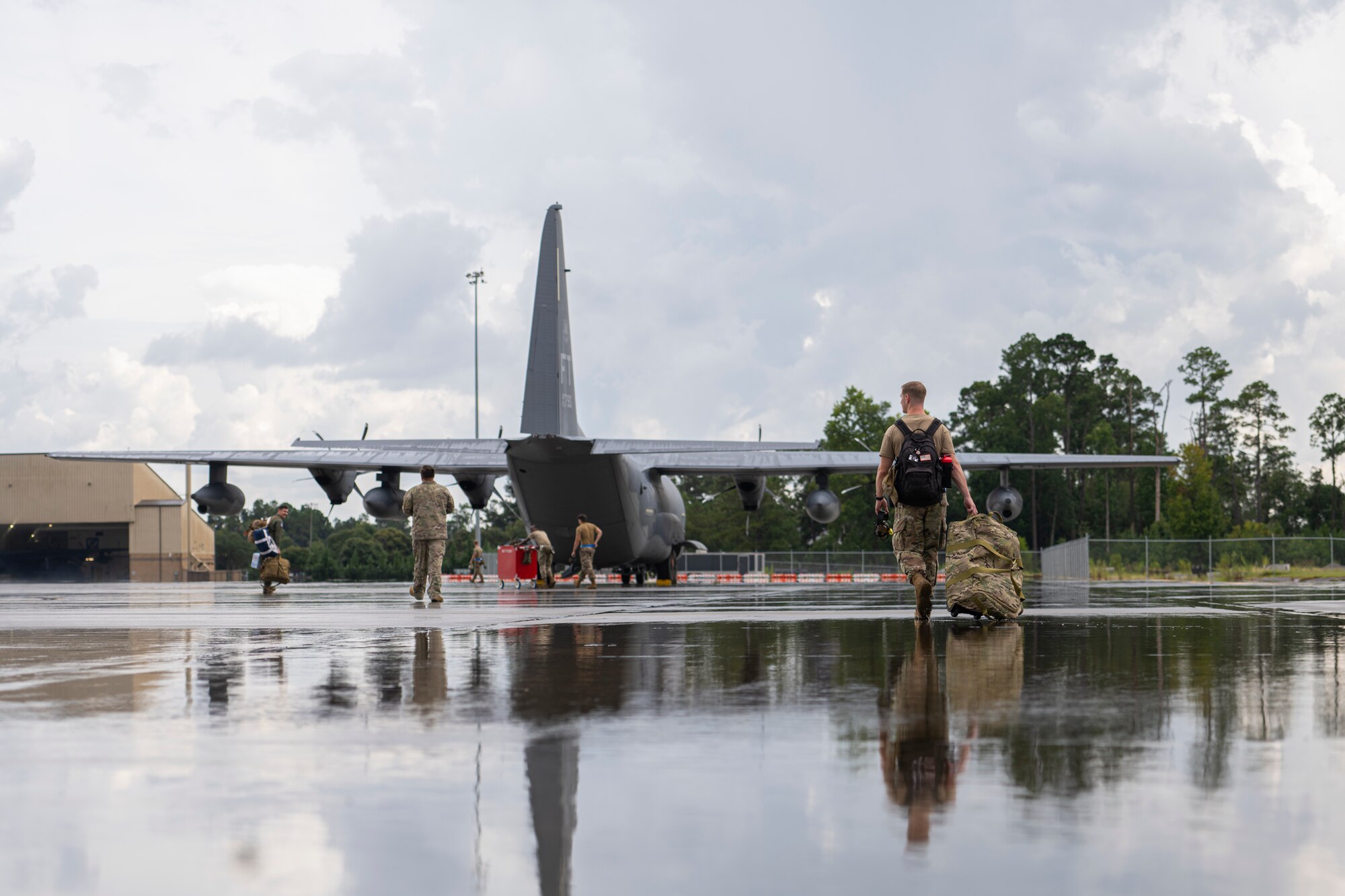 Aircrew walk towards an HC-130.