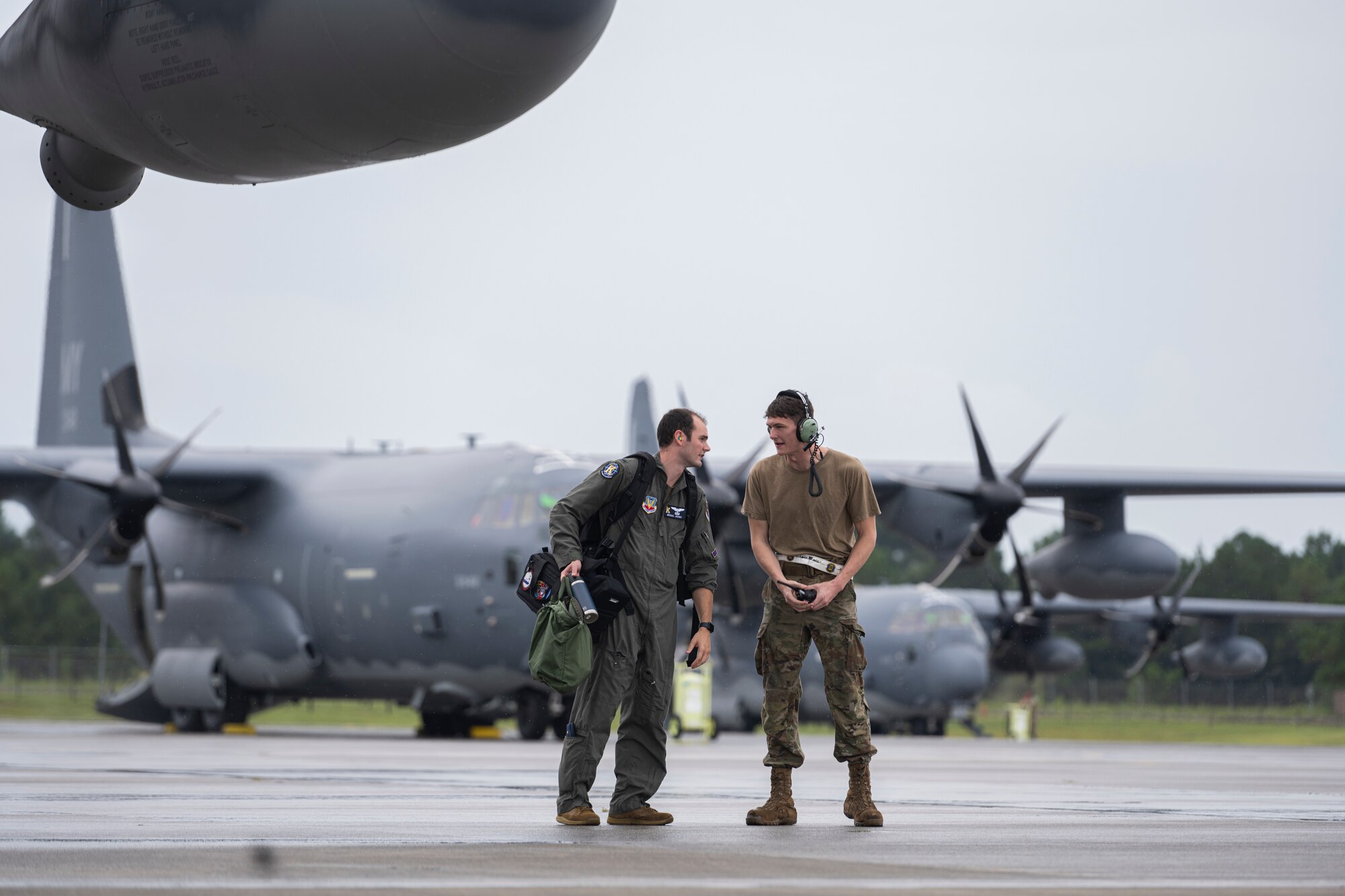 Aircrew talk in front of an HC-130