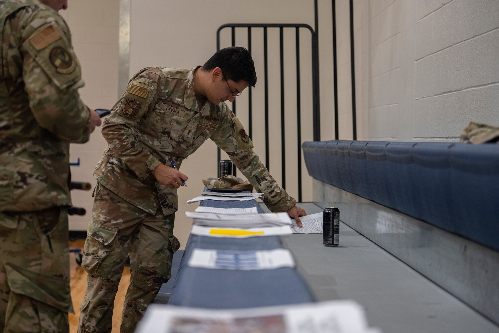 Papers line bleacher seats for an Airman's inspection.