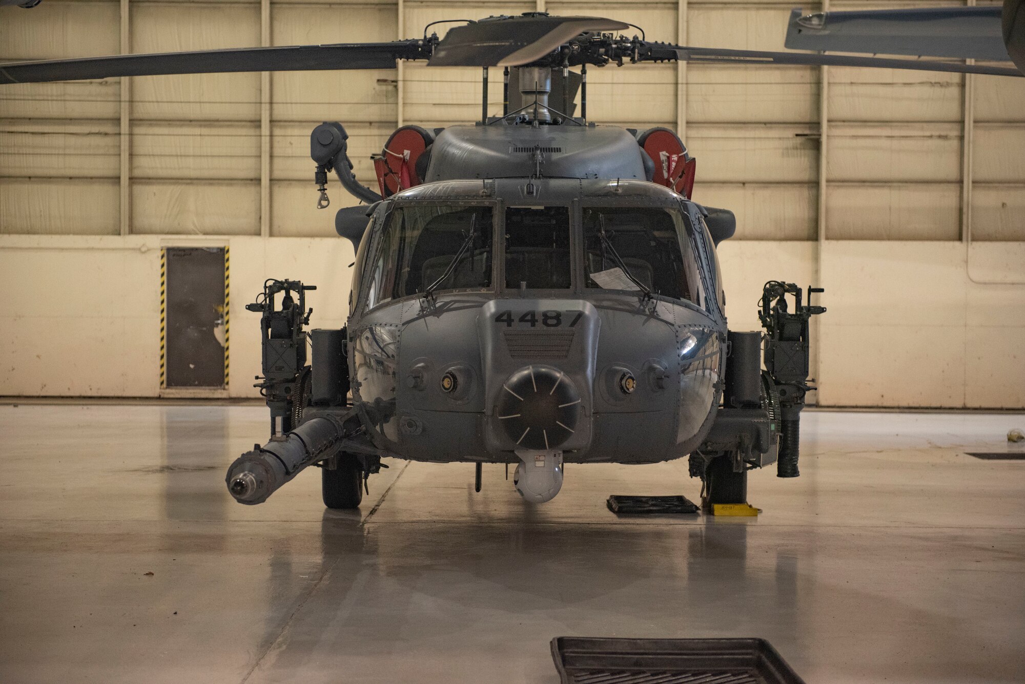 An HH-60W is secured in a hangar.