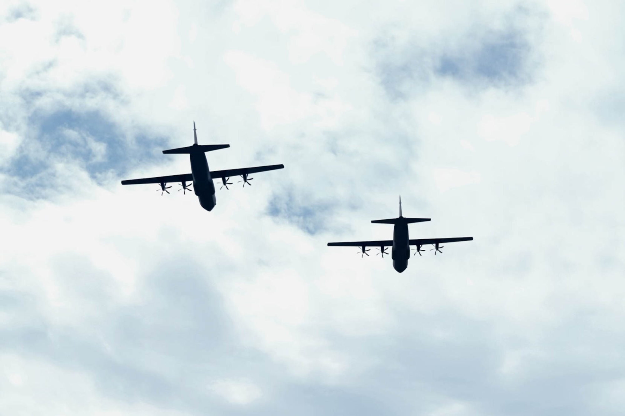 Two C-130J Super Hercules aircraft assigned to the 19th Airlift Wing conduct a flyover at the War Memorial Stadium