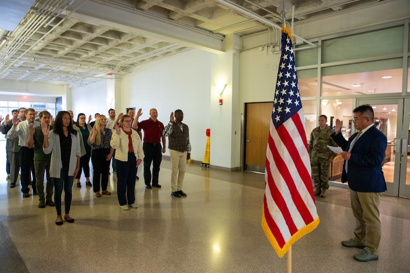 New employees conclude their New Employee Orientation with their Oath of Office, administered by Louis Uptmor, senior resident engineer for the Omaha District, Construction Division's Missouri River area of operations, August 24, 2023 at the headquarters building in Omaha, Nebraska. (U.S. Army photo by Sarah Rich)