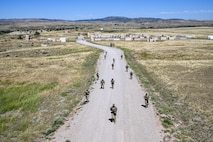 Defenders assigned to the 91st Missile Security Forces Squadron (MSFS) ruck up a hill during Operation Frontier Thunder at Camp Guernsey, Wyoming, Aug. 30, 2023. Operation Frontier Thunder was a deployment readiness exercise designed to test 91st MSFS defender’s expeditionary skills. (U.S. Air Force photo by Airman 1st Class Kyle Wilson)
