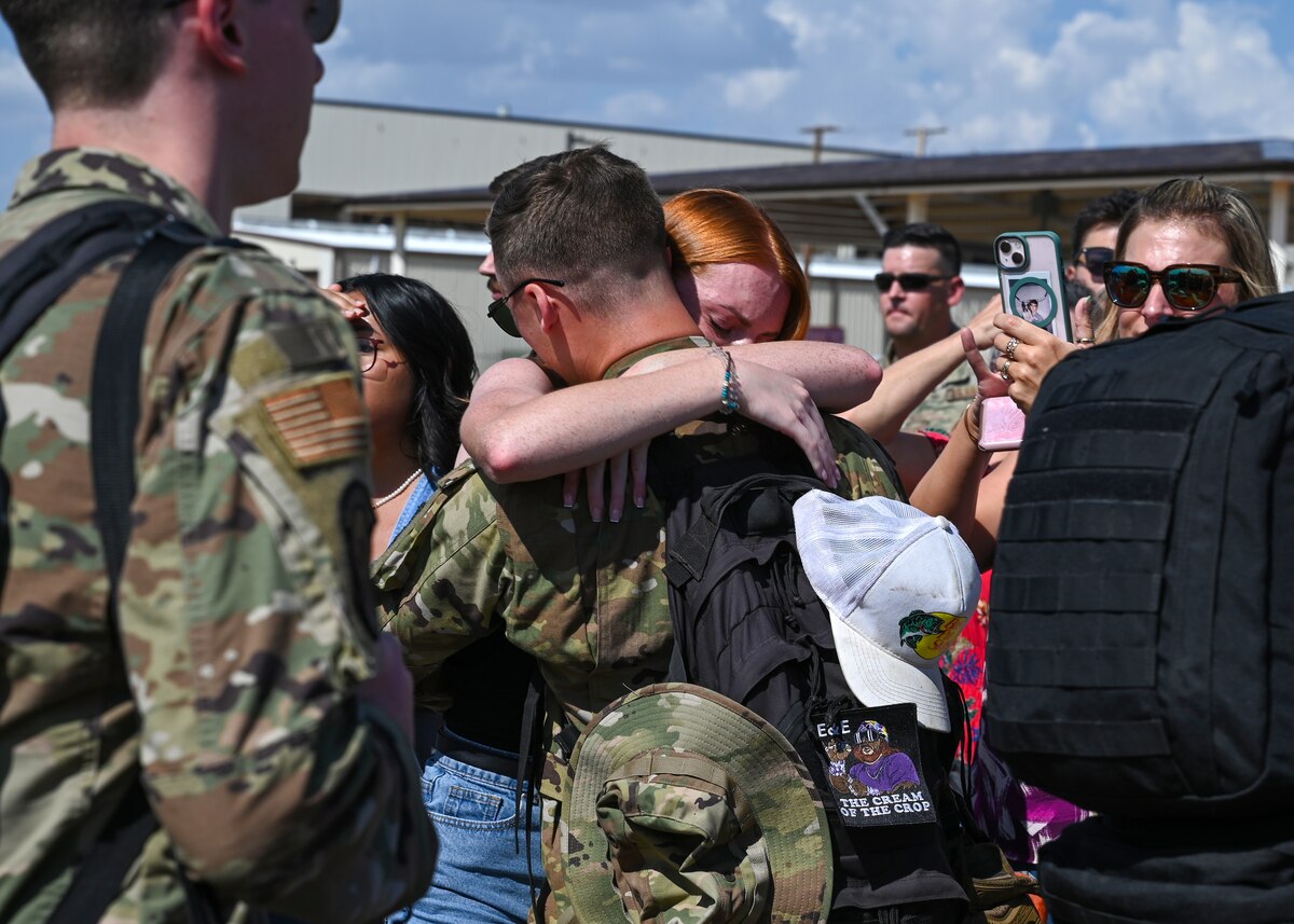 An Airman from the 317th Airlift Wing embraces a loved one.
