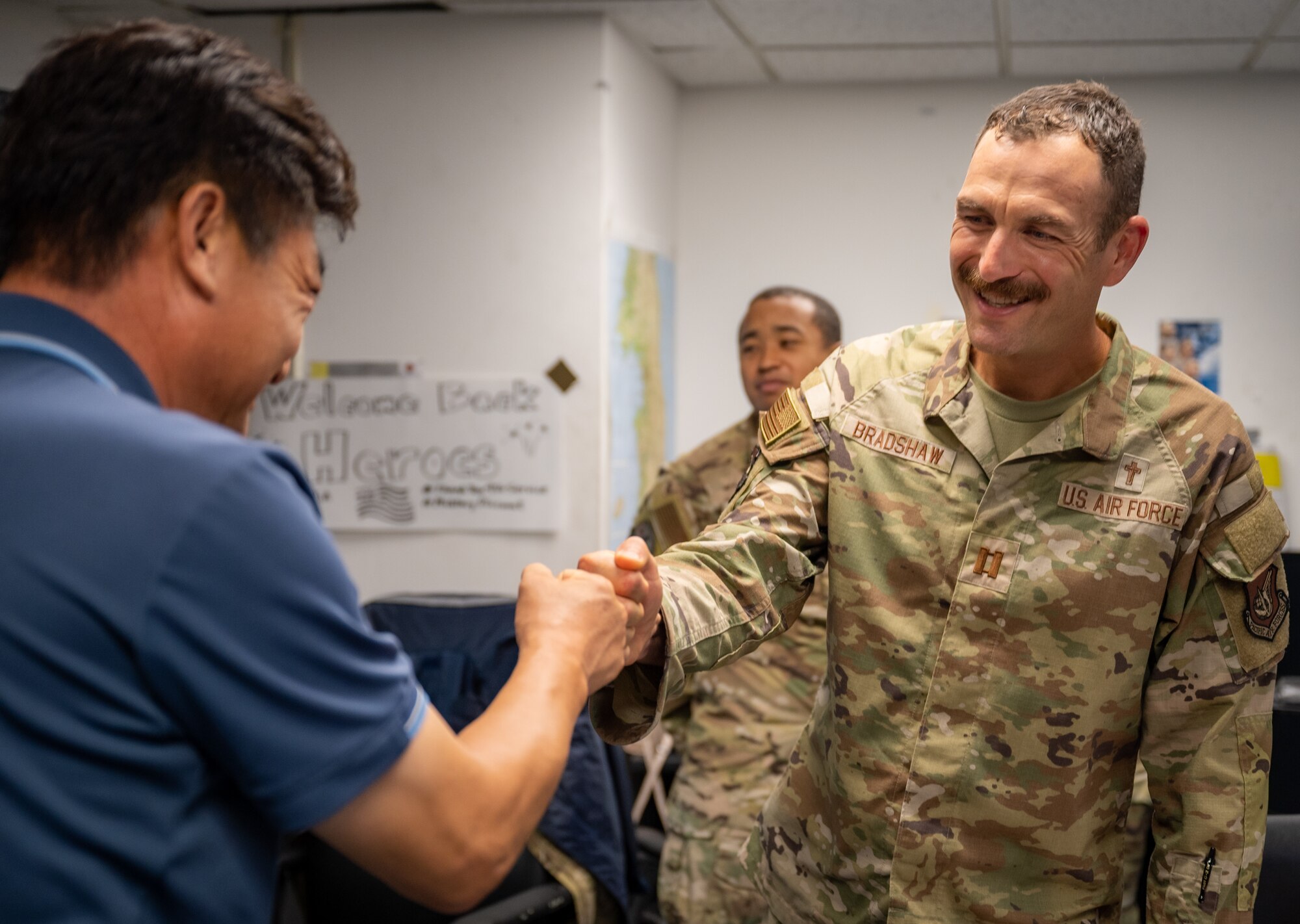 U.S. Air Force Capt. Mark Bradshaw, 51st Fighter Wing chaplain, greets a 51st Civil Engineer Squadron civilian during a 51st Fighter Wing Mission Support Group unit engagement event at Osan Air Base, Republic of Korea, Sept. 6, 2023.