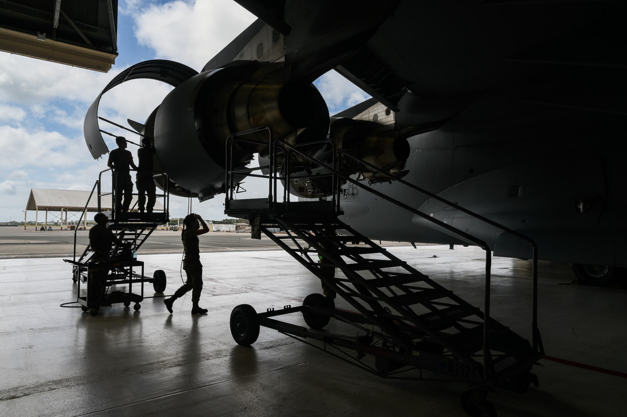 Airmen assigned the 15th Maintenance Squadron propulsions flight evaluate a C-17 Globemaster III during a home station check at Joint Base Pearl Harbor-Hickam, Hawaii, Aug. 7, 2023. A home station check is a mandatory 180-day service that maintainers perform to increase the longevity of a C-17. (U.S. Air Force photo by Staff Sgt. Alan Ricker)