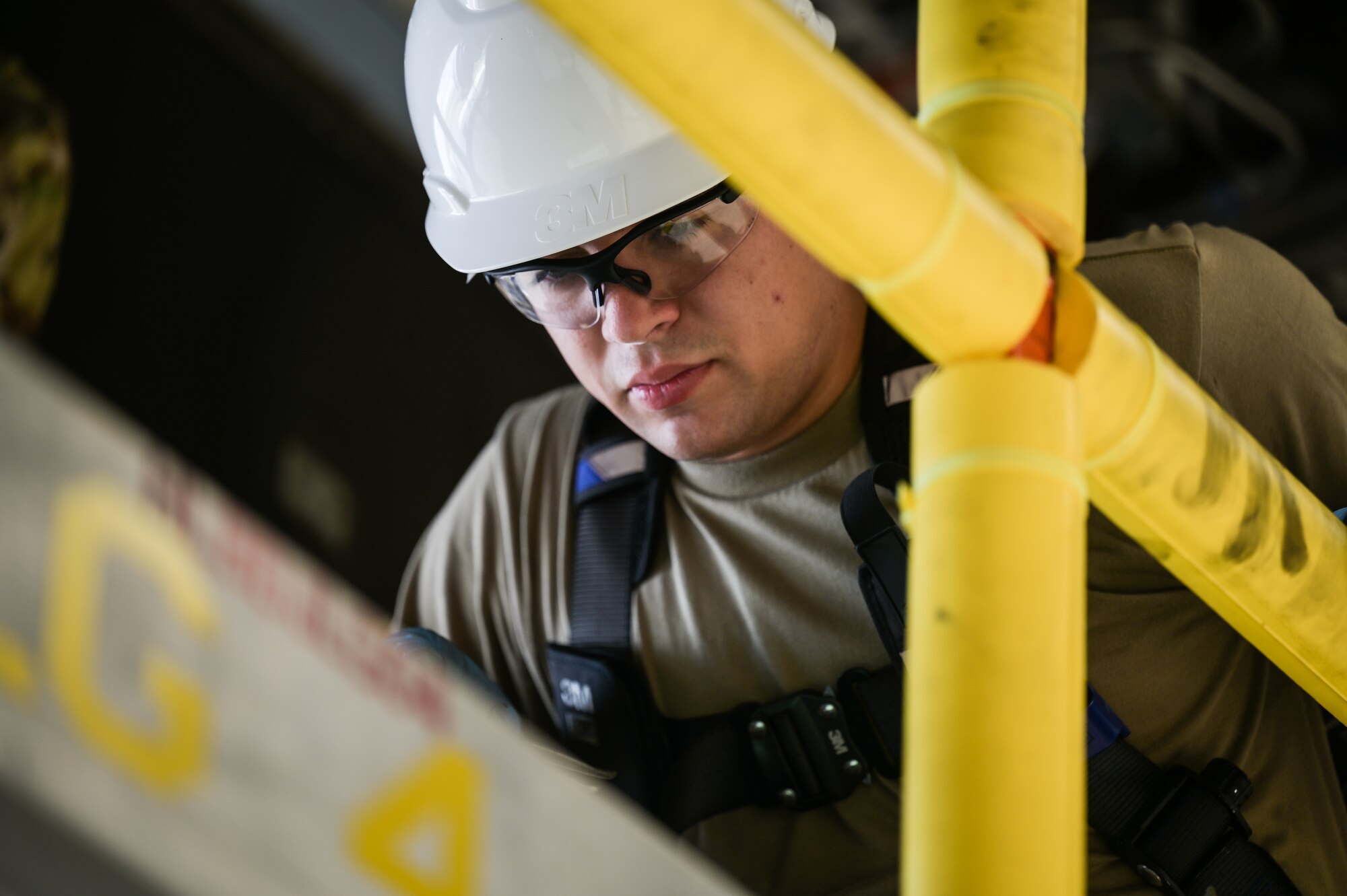Airman 1st Class Michael Adair, 15th Maintenance Squadron crew chief, studies technical order instructions during a C-17 Globemaster III home station check at Joint Base Pearl Harbor-Hickam, Hawaii, Aug. 7, 2023. Maintenance Airmen perform a home station check every 180 days to prolong the aircraft’s operational use. (U.S. Air Force photo by Staff Sgt. Alan Ricker)