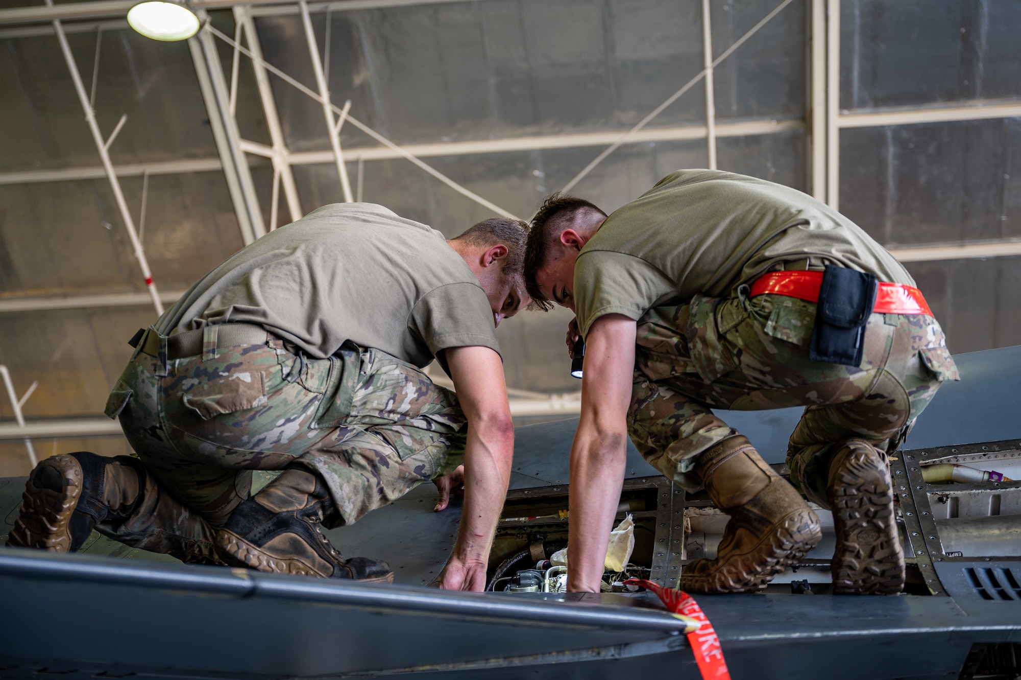 U.S. Air Force Airman 1st Class Brent Parkhurst, left, and Kole Miller, both 36th Fighter Generation Squadron aircraft inspection journeymen, conduct routine maintenance on an F-16 Fighting Falcon at Osan Air Base, Republic of Korea, Sept. 6, 2023. The aircraft maintenance experts of the 36th FGS ensure the F-16s from the 36th Fighter Squadron are at peak performance, always prepared to defend and deter any threat to Osan AB or the ROK. (U.S. Air Force photo by Staff Sgt. Thomas Sjoberg)