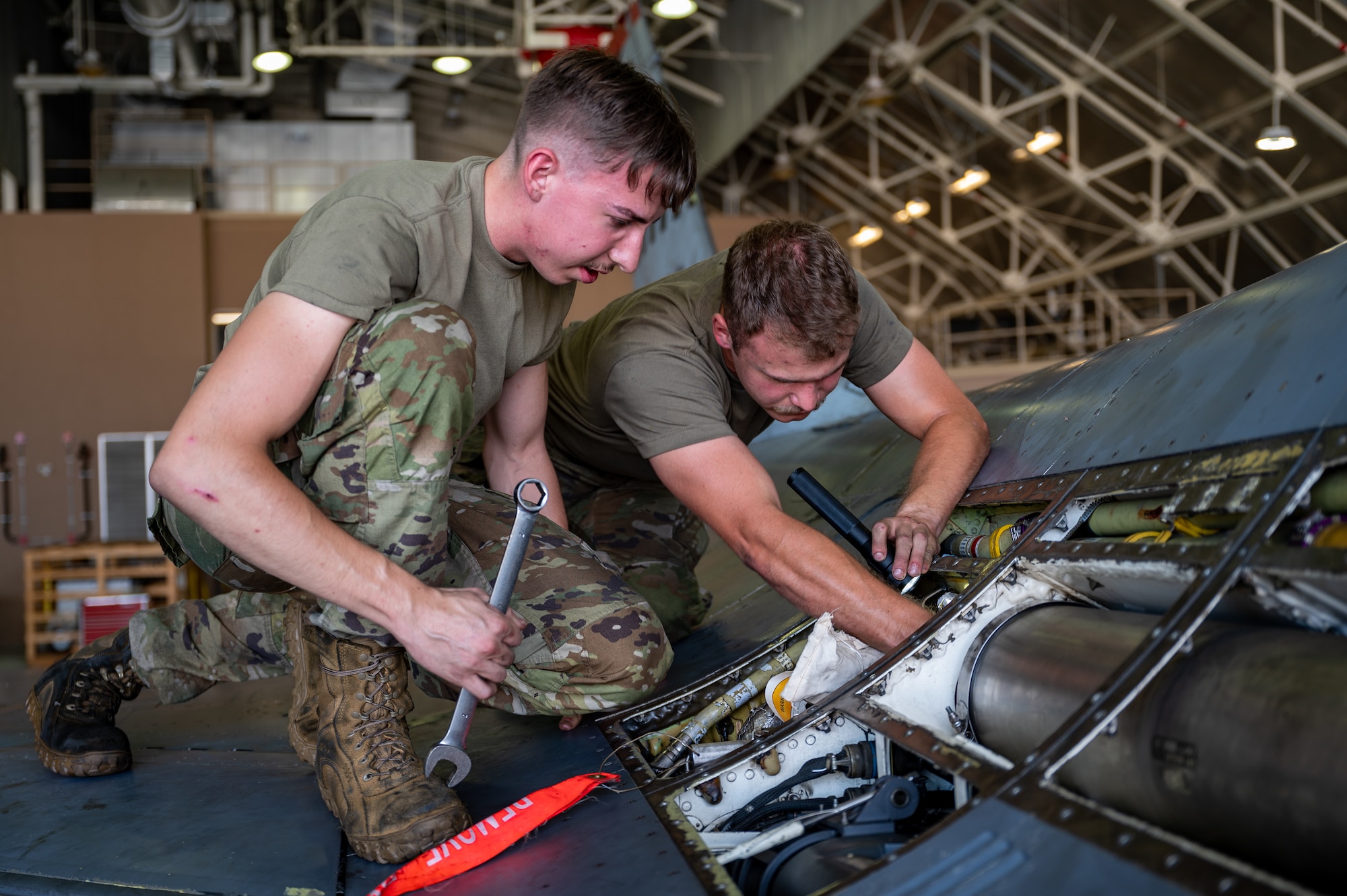 U.S. Air Force Airman 1st Class Brent Parkhurst, left, and Kole Miller, both 36th Fighter Generation Squadron aircraft inspection journeymen, conduct routine maintenance on an F-16 Fighting Falcon at Osan Air Base, Republic of Korea, Sept. 6, 2023. The 36th FGS takes on the crucial task of maintaining the F-16s assigned to the 36th Fighter Squadron. These jets undergo routine maintenance to ensure the 36th FS is always mission-ready and combat-capable. (U.S. Air Force photo by Staff Sgt. Thomas Sjoberg)